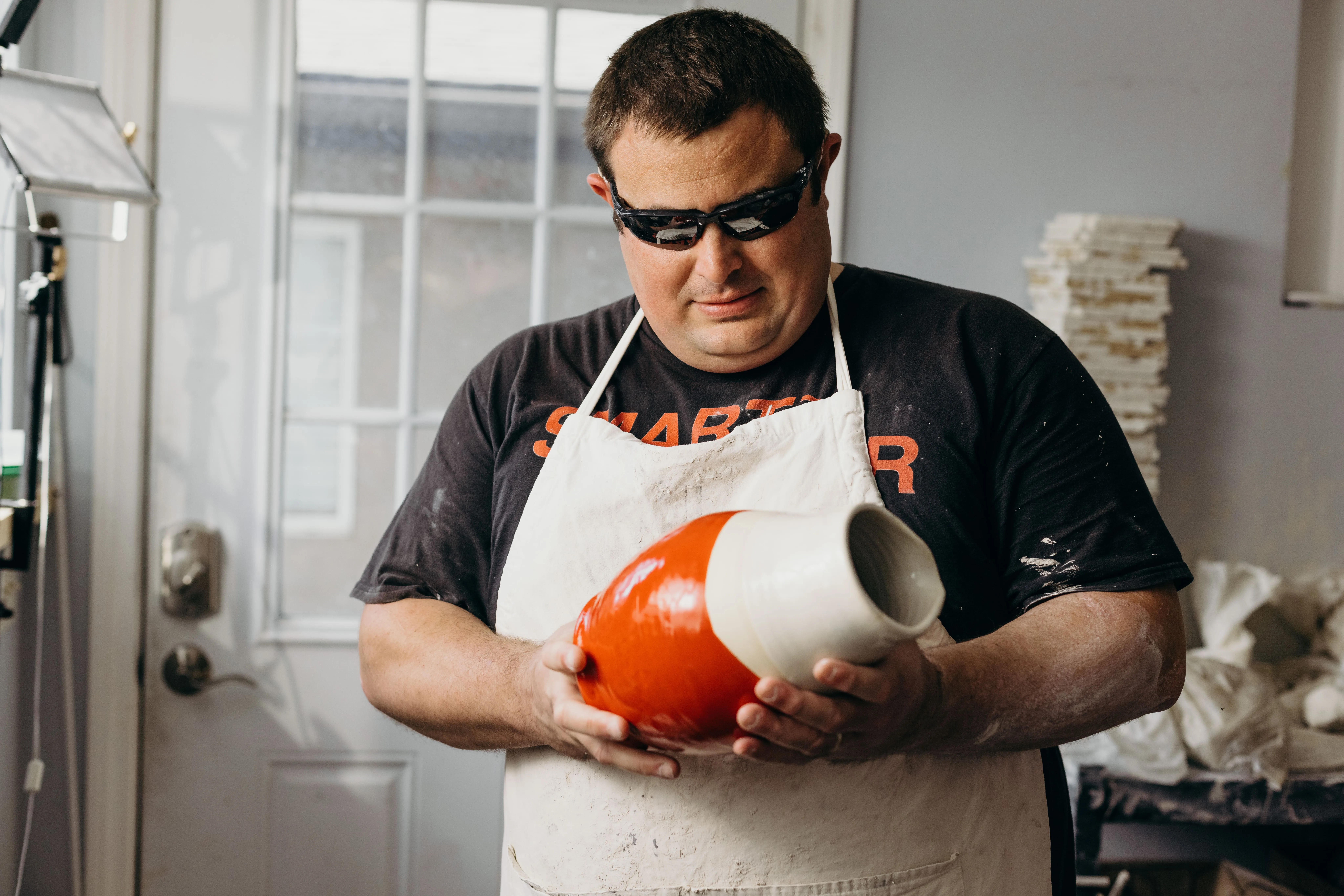 Kelvin holding a vase in the pottery studio Kelvin holding a vase in the pottery studio