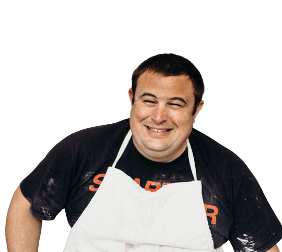 Kelvin Crosby, a deafblind motivational speaker and potter, smiling in a portrait photo.